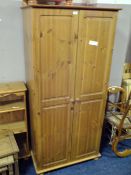 A HONEY PINE DOUBLE WARDROBE AND A BEDSIDE CHEST (2)