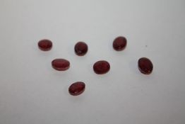 SEVEN ASSORTED RUBY TYPE STONES