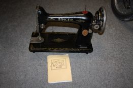 A VINTAGE SINGER SEWING MACHINE WITH INSTRUCTION MANUAL