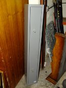 A GUN CABINET WITH KEYS