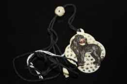 A CARVED AND PIERCED VICTORIAN TYPE IVORY PENDANT DECORATED WITH A LION, H 5.5 cm A/FCondition