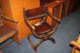 A HEAVY OAK 'X FRAME' ARMCHAIR