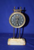 A VINTAGE BRASS AND ONYX GRAVITY CLOCK