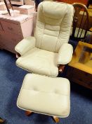 A MODERN CREAM ARMCHAIR AND FOOTSTOOL A/F