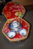 AN ORIENTAL STYLE BLUE AND WHITE TEA SET IN A WICKER CARRY CASE