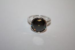 A STERLING SILVER AND BLUE MOISSANITE DRESS RING