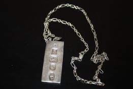 A HALLMARKED SILVER INGOT ON CHAIN