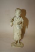 A JAPANESE CARVED IVORY OKIMONO, depicting an artist / scholar, the right hand with a missing
