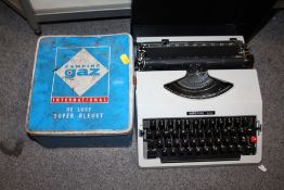 AN IMPERIAL 285 PORTABLE TYPEWRITER TOGETHER WITH A GAS CAMPING STOVE