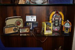 A COLLECTION OF VINTAGE RADIOS, A JUKE BOX RADIO AND MONEY BANKS ETC (9)