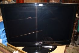 A SAMSUNG 40 INCH FLAT SCREEN TV WITH REMOTE AND INSTRUCTIONS