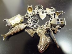 A STERLING SILVER CHARM BRACELET, APPROX TOTAL WEIGHT 63.3G