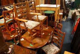 AN OAK DINING TABLE AND 6 CHAIRS