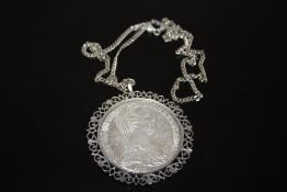 A COIN PENDANT ON SILVER CHAIN