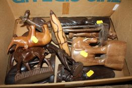 A BOX OF CARVED AFRICAN TRIBAL FIGURES TOGETHER WITH A MASSAGE STICK