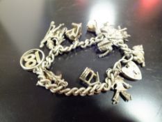 A STERLING SILVER CHARM BRACELET, APPROX TOTAL WEIGHT 55.5G