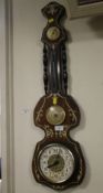 A DECORATIVE WALL HANGING BAROMETER IN THE SHAPE OF A MUSICAL INSTRUMENT