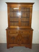 A SOLID OAK DISPLAY GLAZED WALL UNIT