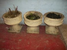 THREE RECONSTITUTED STONE GARDEN PLANTERS