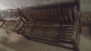 A WOODEN GARDEN BENCH