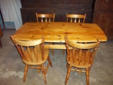 A SOLID PINE DINING TABLE AND FOUR CHAIRS