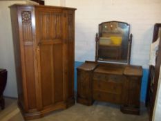 AN OAK TWO PIECE BEDROOM SUITE TO INCLUDE A TWO DOOR WARDROBE AND A DRESSING TABLE BY CROWN AX
