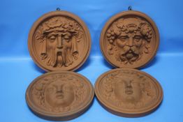 FOUR TERRACOTTA CLASSICAL STYLE HANGING FACE PLAQUES