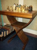 A GAMES TABLE WITH CHESS PIECES BY NIGRI ITALIAN PRODUCTS