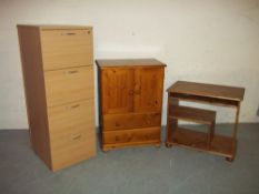 A WOOD EFFECT FILING CABINET, A SOLID PINE MEDIA / DRINKS UNIT AND A SOLID PINE COMPUTER DESK