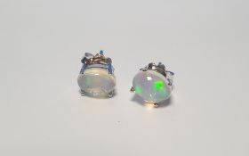 A PAIR OF CABOCHON WHITE OPAL SILVER STUDS