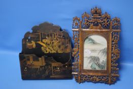 AN ORIENTAL STYLE FRAME TOGETHER WITH AN ORIENTAL STYLE PAPIER MACHE LETTER RACK