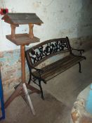 A CAST GARDEN BENCH AND A BIRD HOUSE FEEDER