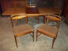 A TEAK EXTENDING TABLE AND FOUR CHAIRS BY MCINTOSH
