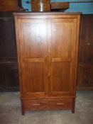 A MEDIUM OAK TWO DOOR DOUBLE WARDROBE