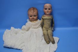 A VINTAGE ARMAND MARSEILLE PORCELAIN HEADED DOLL TOGETHER WITH ANOTHER A/F