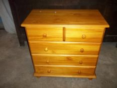 A SOLID PINE THREE DRAW CHEST OF DRAWS, TWO OVER THREE