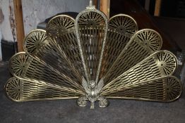 A VINTAGE BRASS PEACOCK FAN FIREGUARD