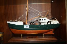A HAND BUILT WOODEN MODEL OF A TRAWLER ON STAND