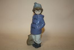 A NAO FIGURE OF A YOUNG BOY WITH A SATCHEL