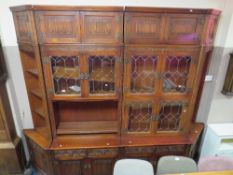 A LARGE 'OLD CHARM' LEADED AND GLAZED OAK LINENFOLD WALL DISPLAY CABINET WITH CORNER AND TOP BOXES H