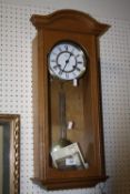 A MODERN HERMLE WALL CLOCK WITH KEY