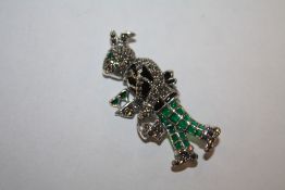 A STERLING SILVER PLIQUE DE JOUR BROOCH IN THE FORM OF A RABBIT CARRYING FOOD AND DRINKS