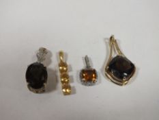 FOUR SILVER AND SILVER GILT VINTAGE PENDANTS, TO INCLUDE CITRINE, TWO LARGE SMOKEY QUARTZ ETC. (4)