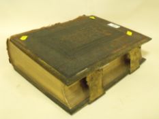 AN ANTIQUE BRASS AND LEATHER BOUND HOLY BIBLE A/F
