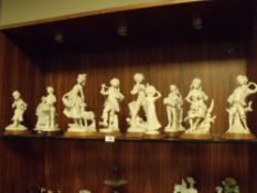 A COLLECTION OF MODERN RESIN FIGURES ON WOODEN PLINTHS (11)