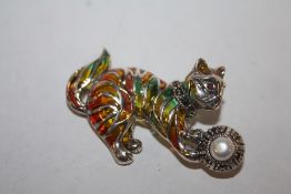 A STERLING SILVER PLIQUE DE JOUR BROOCH IN THE FORM OF A CAT WITH A BALL