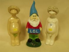 A PAIR OF NOVELTY NUDE CERAMIC FIGURES TOGETHER WITH A GARDEN GNOME