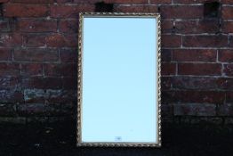 A GILT FRAMED WALL MIRROR, OVERALL SIZE 72 X 44 CM