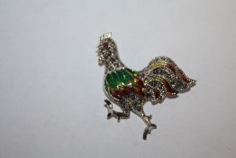 A STERLING SILVER PLIQUE DE JOUR BROOCH IN THE FORM OF A COCKEREL