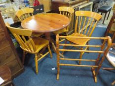 A HONEY PINE CIRCULAR PEDESTAL TABLE, 4 CHAIRS AND A TOWEL RAIL
